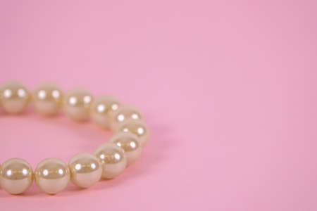 A beautiful pearl bracelet on pink background. Blank copy space for own text.の写真素材