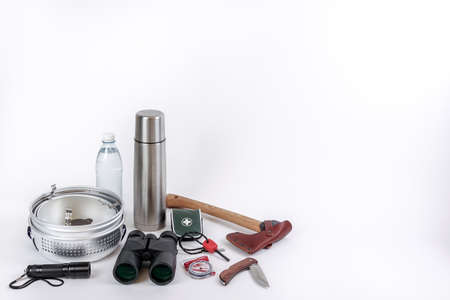 Gears for a survival / bug out bag. Checklist for things / gears you need to survive in the wilderness or after the apocalypse. An ax, binoculars, compass, first aid, etc.の写真素材