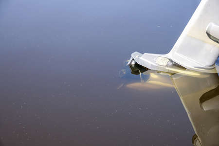 Old outboard boat engine immersed in water. Copy space for text.の写真素材