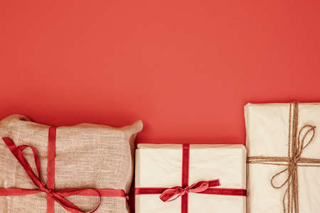 Christmas gift boxes on red background. Copy space for text or product.の写真素材