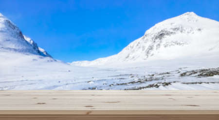 Empty table top for product display montage. Snowy mountains in Sweden blurred in the background.の写真素材