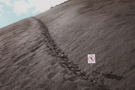 No trespassing sign. Walking path on a volcano. Lanzarote, Canary Islands.の写真素材