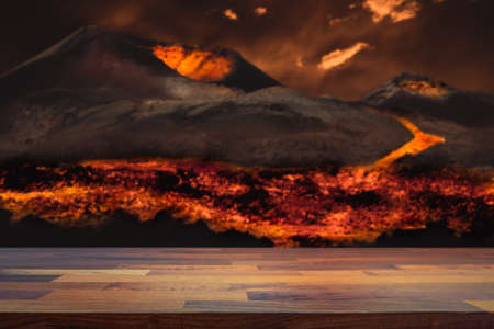 Empty table top for product display montage. Lava flowing from volcano eruption blurred in the background. Concept for heat and hell.の写真素材