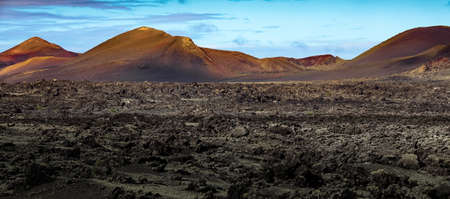 Beautiful volcanic landscape background. Mountain range with lava fields in the foreground. Lanzarote, Canary Islands.の写真素材
