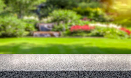 Lawn and flowers in botanical garden. Empty table top for product display montage background.の写真素材