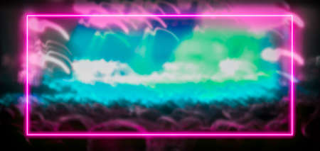 Pink and turquoise neon light frame with crowd at festival concert in the background. Copy space for...