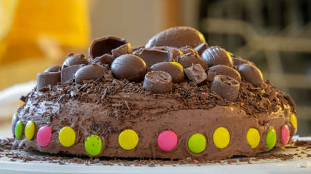 Home made tasty chocolate cake with chocolate icing and topping.