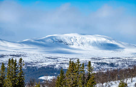Winter landscape with dramatic snowy mountains.の写真素材