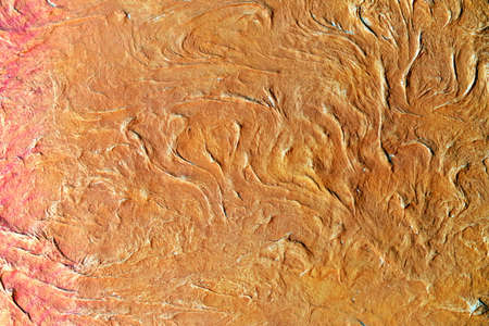 Embossed surface with curls of orange colorの写真素材