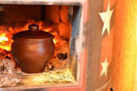 Cooking in a wood stove on fireの写真素材