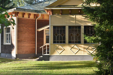 Country yard with the facade of a wooden decorated house in a quiet placeのeditorial素材