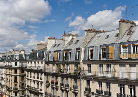 View of upper floors and rooftops of street and apartments in Paris in the Latin Quarterの写真素材