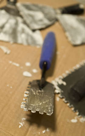 Extreme selective focus view of a tile setting trowel for tile setting.