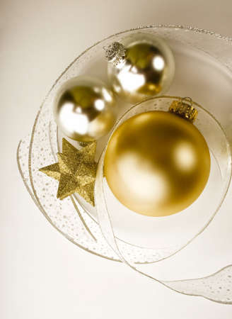 Silver and gold Christmas ornaments, a glittery gold star and fancy lace ribbonの写真素材