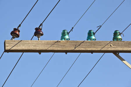 Closeup of old telephone pole with glass insulatorsの写真素材