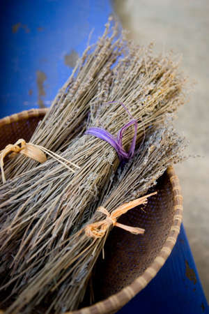 Bundles of dried lavender tied with raffia in a basketの写真素材