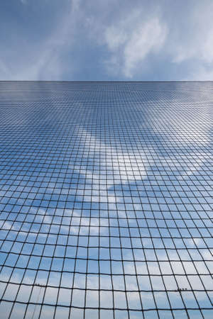 Looking straight up at the sky behind the backstop net at a baseball field. Extreme wide angle view.の写真素材