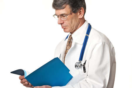 Doctor in closeup view reading a patient's file in a folder.の写真素材