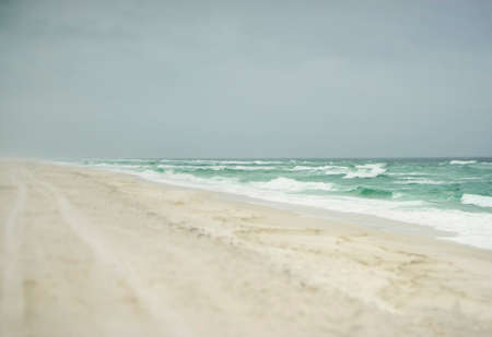 Beautiful beach on a stormy day in Florida on the Gulf of Mexico with fog, mist and sea sprayの写真素材