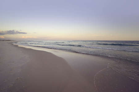Wide angle seascape at dawn at Pensacola, Florida Beach. Pink, mave and soft grays and blues.の写真素材