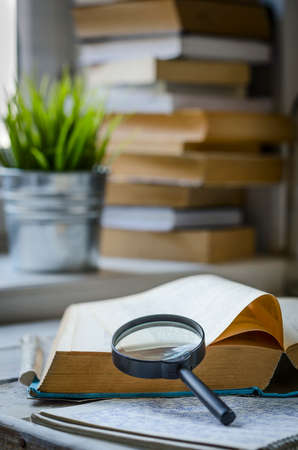 books and magnifying glass
