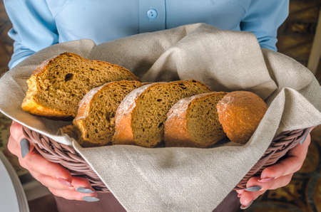 hands hold basket of bread