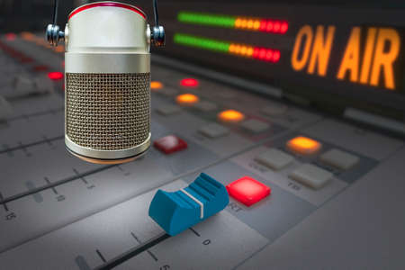 Professional microphone in radio station studio and on air sign