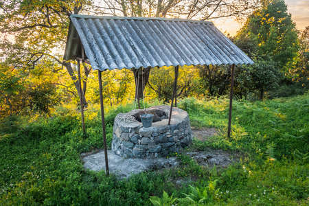 stone well under the roofの写真素材