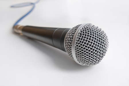 microphone with blue cable on white table