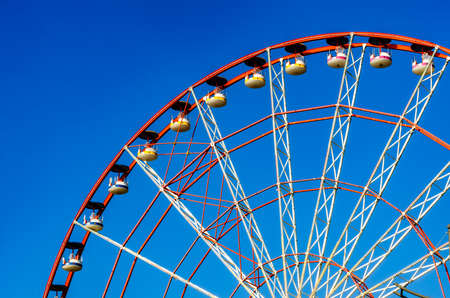 fragment of a ferris wheel against a blue sky