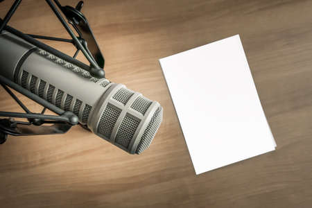 Professional microphone and blank sheet of paper