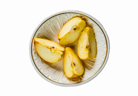 pieces of ripe pear on a white plateの写真素材
