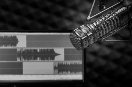 Background with a professional microphone and wave form on screenの写真素材
