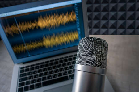 Background with a professional microphone and wave form on screenの写真素材