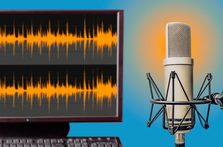 professional microphone and sound wave form on computer screenの写真素材