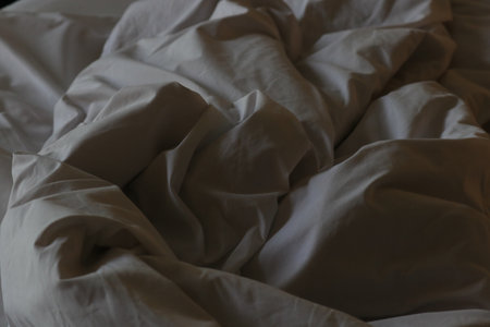 Close-up of white crumpled bedding sheets. Horizontal photo