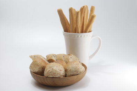 Breadsticks in a wooden cup on a white background. High quality photo