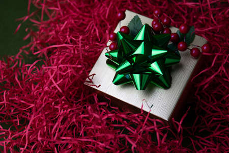 Christmas decoration,
Green Shiny Bow on Silver Gift Box, Red Backgroundの写真素材