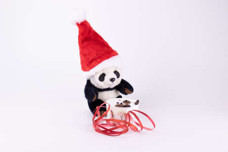 Panda Plush Doll wearing red Santa Hat  and Christmas Ornament  on White Backgroundの写真素材