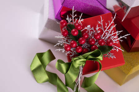 Red Gift box on white background with messy red ribbon and ornaments for gift decoration , red berries, green firの写真素材
