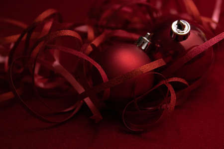 Christmas Ornaments for Decoration. Red berries, Pine Cone, Hanging Balls, Green Fir and Red Ribbon. Red Backgroundの写真素材