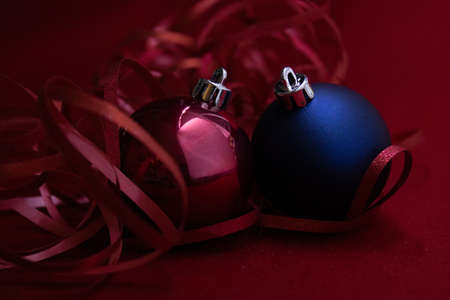 Christmas Ornaments for Decoration. Red berries, Pine Cone, Hanging Balls, Green Fir and Red Ribbon. Red Backgroundの写真素材