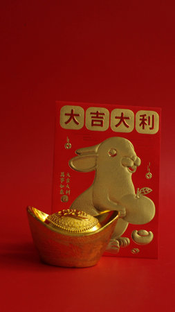 Gold Ingot and the Lucky Red Envelope with the Script in Chinese, Good Luck and Rabbit in Gold printedの写真素材