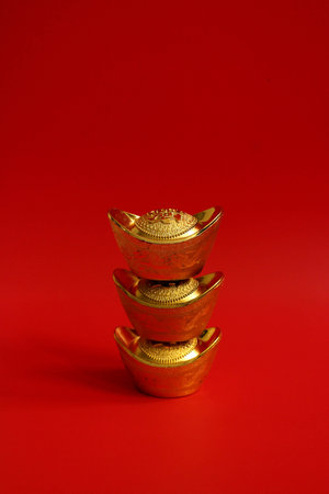 Chinese gold ingots on Red Background for Decorationの写真素材