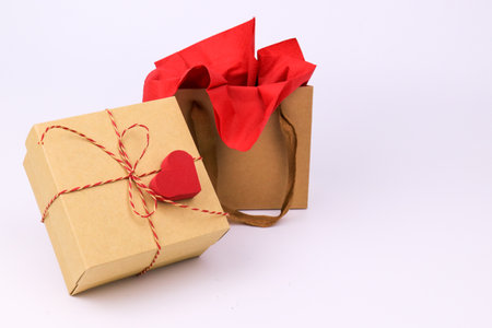 Gift box with red heart on white background. Valentines day concept.