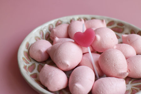 Pink Meringue in white plate topped with a pink Heart