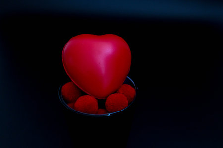 red heart and red pom-pom for celebrating Valentine's dayの写真素材