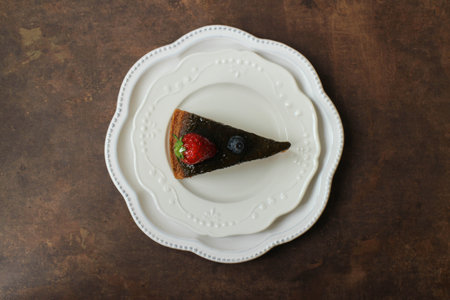 Pistachio Cake topped with fresh strawberry  on a white plate, top viewの写真素材