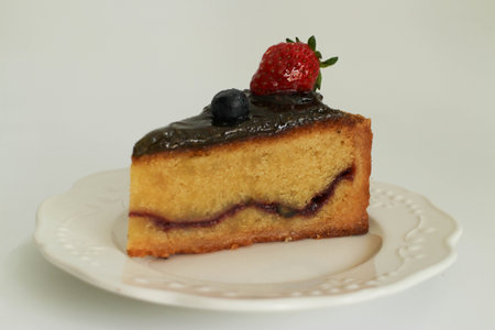Pistachio Cake topped with fresh strawberry  on a white plate