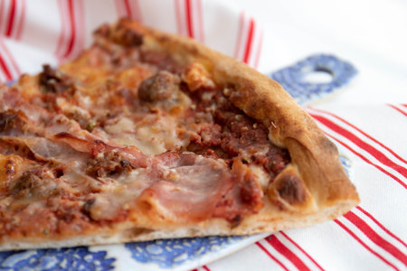 Tasty Italian Menu, a slice of Meat Lover Pizza on white back groundの写真素材